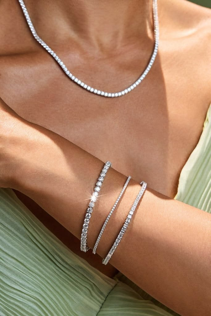 Three diamond tennis bracelets catching sunlight