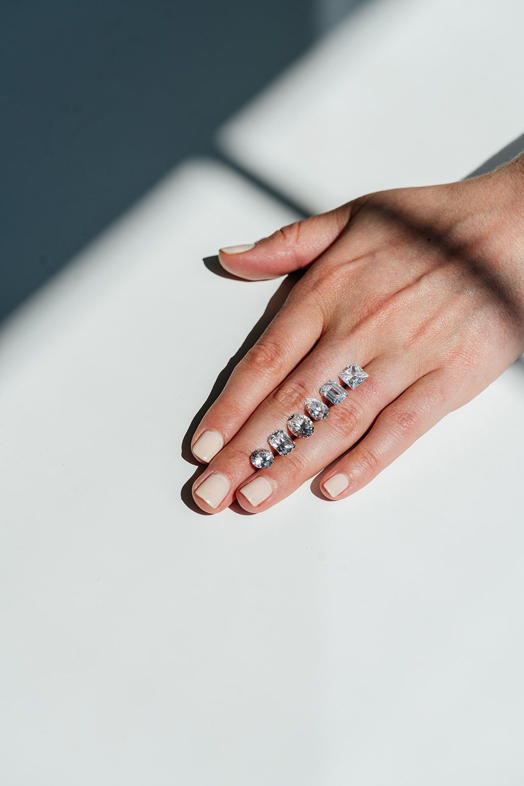 Loose diamonds in several cuts resting on a hand
