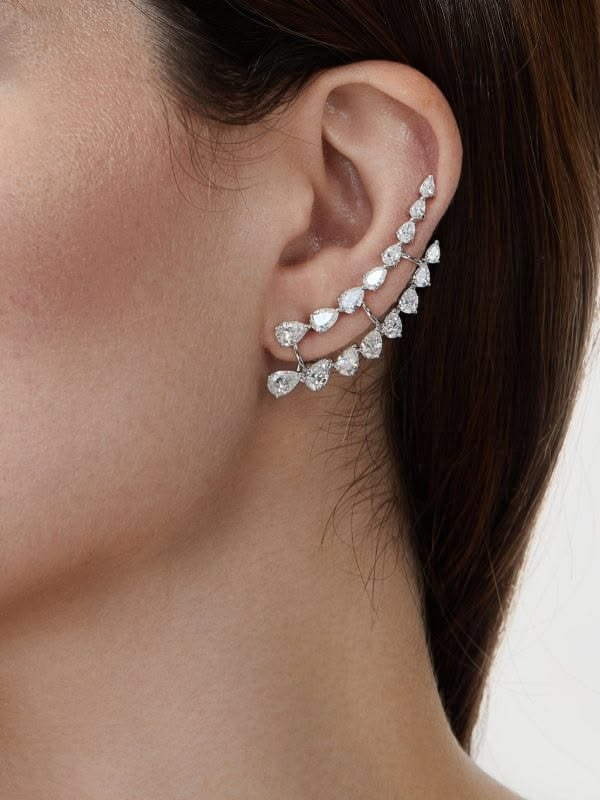 Pear-cut diamond ear climber worn on the ear