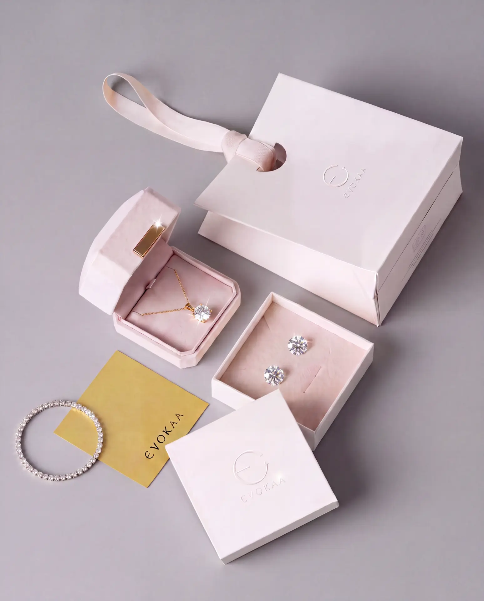 Evokaa packaging with a diamond necklace, studs and tennis bracelet